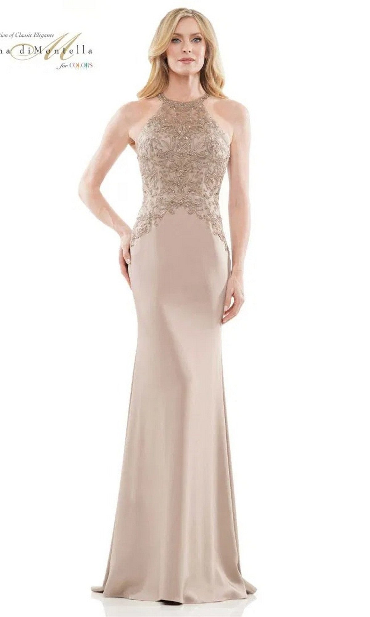A woman models the Rina Di Montella RD2755, a long formal dress featuring a sleeveless, embroidered bodice and a flowing, floor-length beige skirt against a plain background.